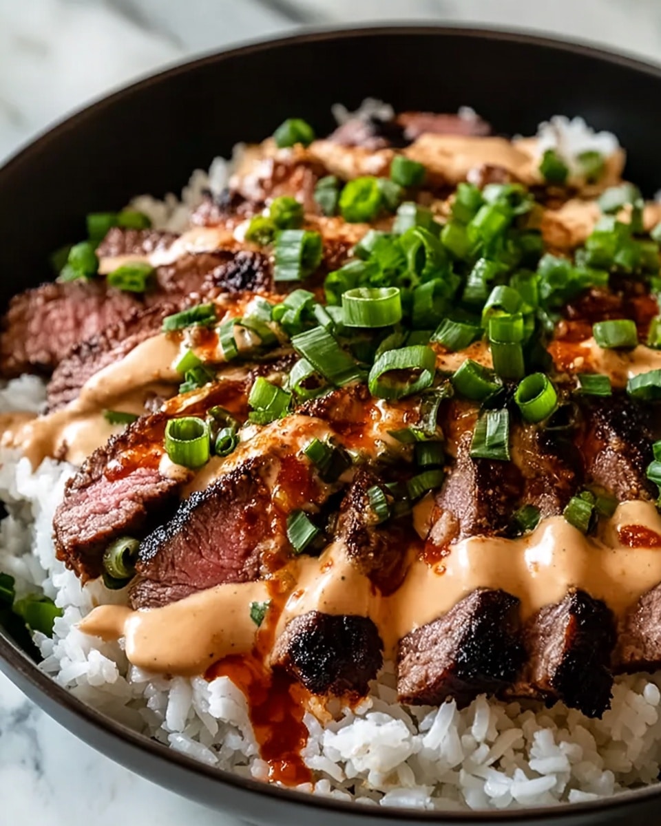 A close-up of a black bowl filled with a base layer of white rice showing round, soft grains. On top of the rice, there are several slices of grilled steak, each piece showing a charred, dark brown outer edge with a pinkish center. Over the steak, there is a creamy light tan sauce drizzled generously, with a reddish-brown oily sauce spread unevenly around it. Bright green chopped scallions are scattered on top of the sauces, adding a fresh pop of color. The bowl is placed on a white marbled texture surface. photo taken with an iphone --ar 4:5 --v 7