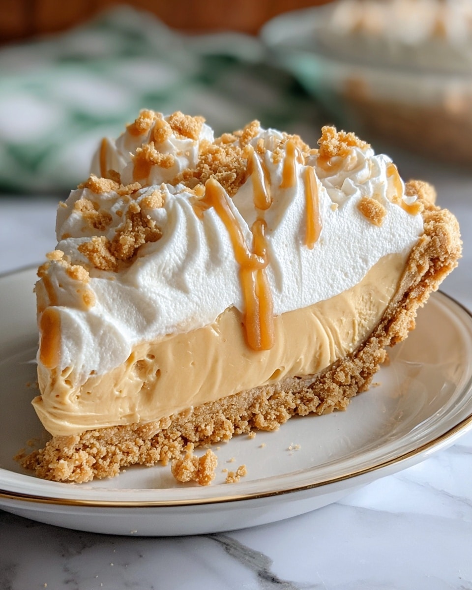 The image shows a slice of pie with three main layers. The bottom layer is a crumbly, light beige crust with a rough texture, holding the pie together. Above that is a thick, smooth caramel-colored filling with soft swirls on the side. The top layer is fluffy white cream, piped into soft peaks and spread over the filling. Scattered on the cream are small light brown crumbs and thin caramel drizzles, adding texture and color contrast. The slice sits on a white plate with a subtle gold trim, all set on a white marbled surface. Photo taken with an iphone --ar 4:5 --v 7
