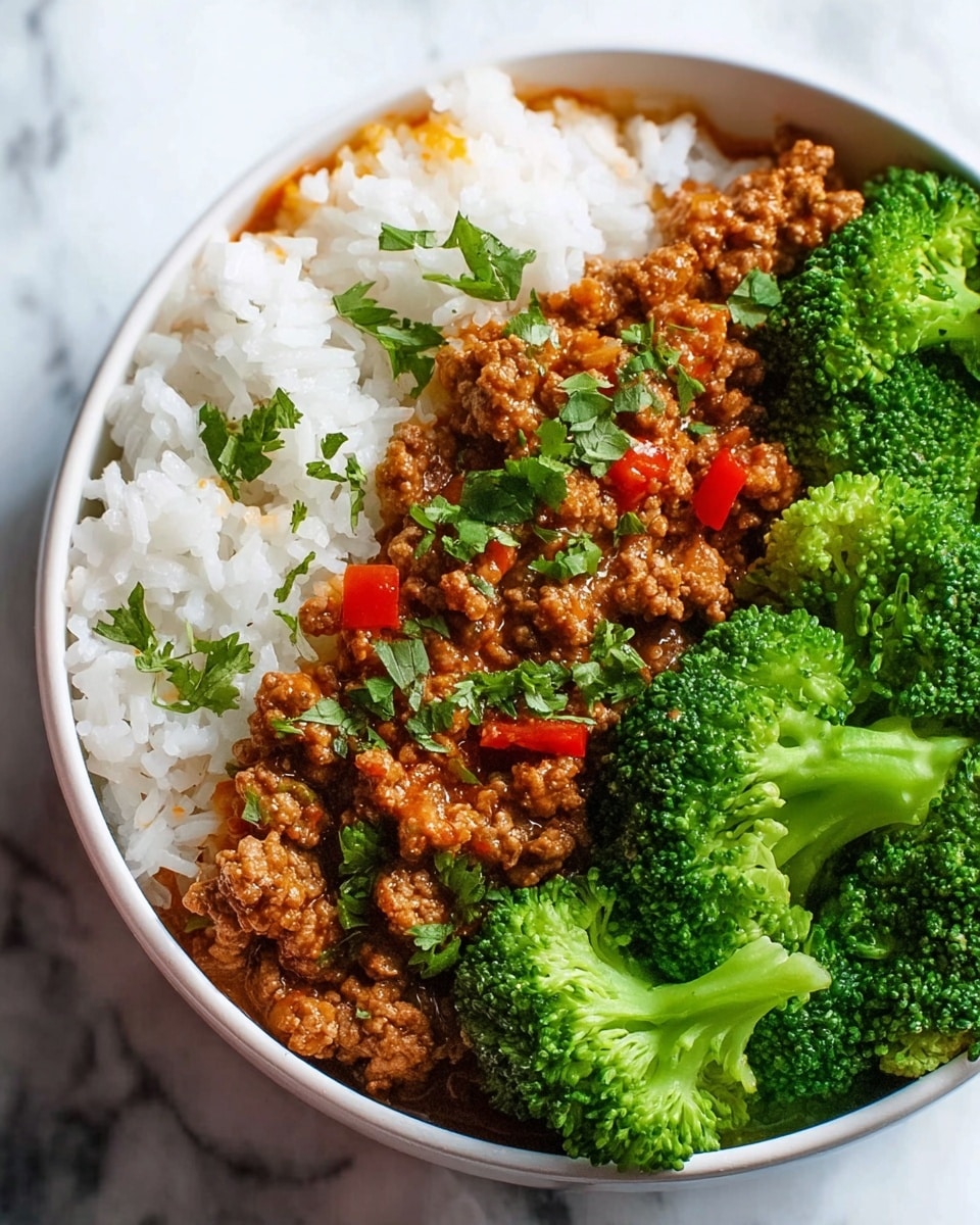 A white bowl with three main layers: on the left, a fluffy white rice layer with small bits of orange visible through it and some green herb leaves sprinkled on top; in the center, a thick layer of cooked ground meat covered in a rich brown sauce with small pieces of red bell pepper and fresh green herbs scattered over it; on the right, bright green broccoli florets that look steamed and fresh. The bowl is placed on a white marbled surface. Photo taken with an iphone --ar 4:5 --v 7